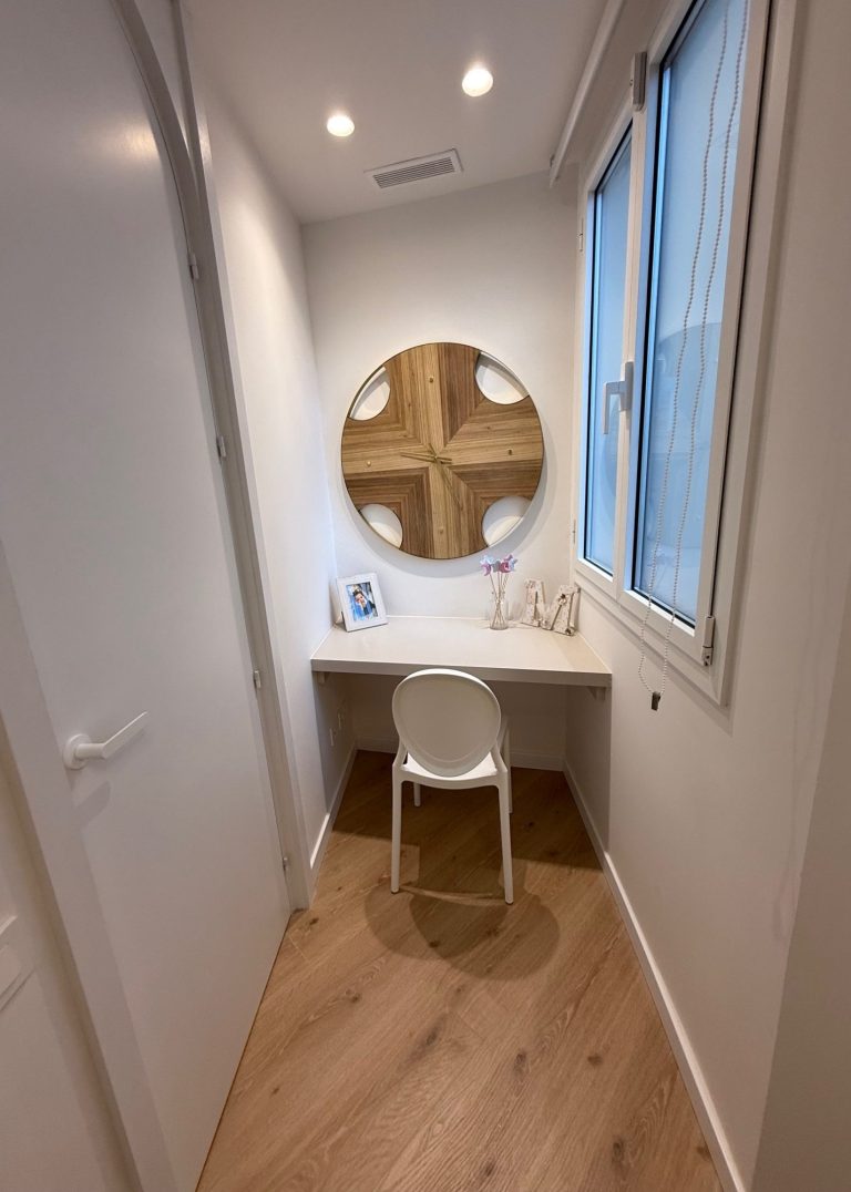 Dormitorio acogedor con cama, ventanas de madera y decoración moderna en tonos claros.